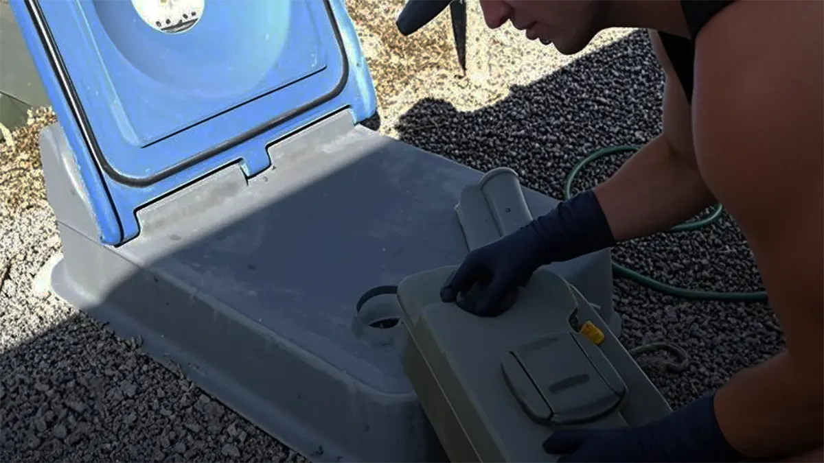 Man pours waste water into designated sewage point