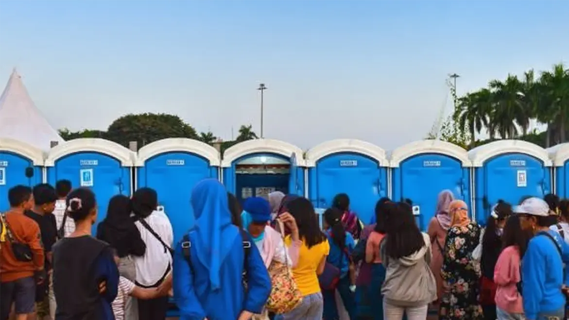 Outdoor portable toilets line up for use